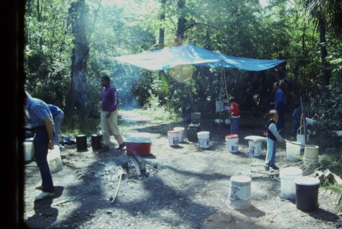 This image is from an early Father-Son canoe trip. Osceola Landing was the preferred camping spot for almost two decades before it became too popular to guarantee a place for up to forty canoers. 
The early trips had no chairs, just buckets. There was an eight canoe limit (later trips grew to 16 canoes.